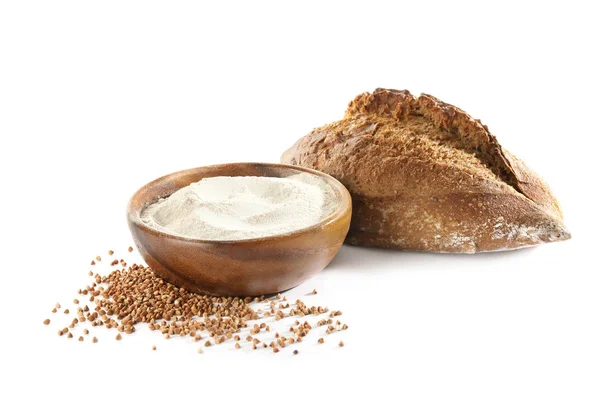 Bowl with buckwheat flour and loaf of bread — Stock Photo, Image