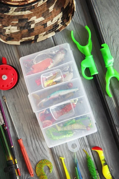 Fishing bait box and other equipment on wooden table — Stock Photo, Image