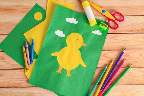 Child's applique of chick on wooden table — Stock Photo, Image