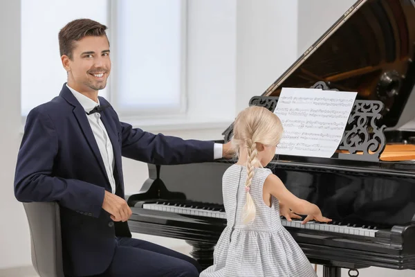 Meisje en jonge mannetje pianospelen — Stockfoto