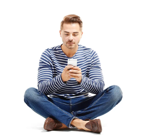 Young handsome man with mobile phone against white background — Stock Photo, Image