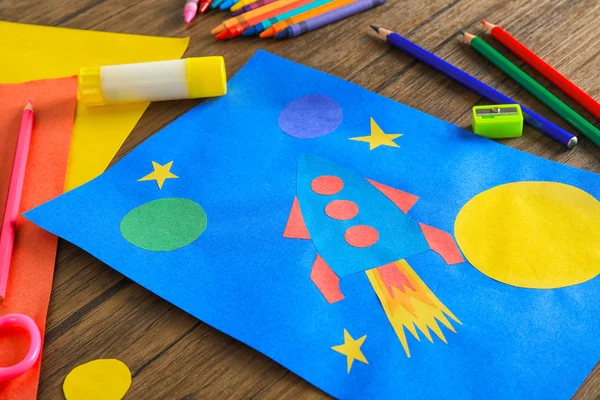 Child's applique of rocket on wooden table — Stock Photo, Image