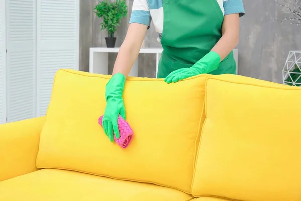 Woman cleaning couch