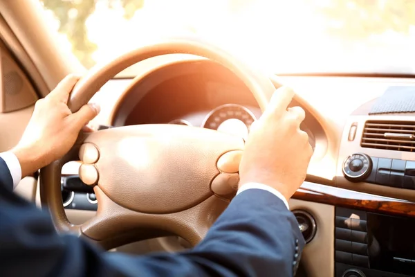 Young businessman driving a car, closeup — Stock Photo, Image