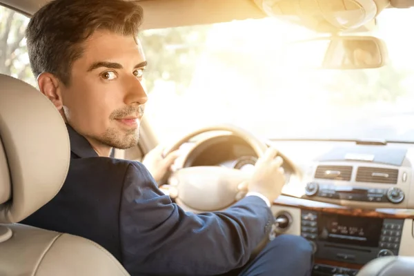 Young businessman driving a car — Stock Photo, Image