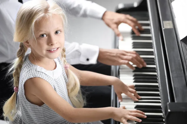 Man en klein meisje speelde piano — Stockfoto