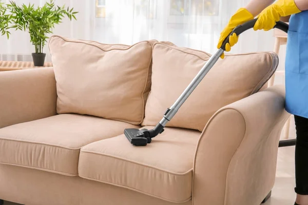 Woman cleaning couch