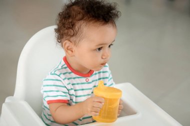 Şirin bebek şişe iskemlede kapalı su ile