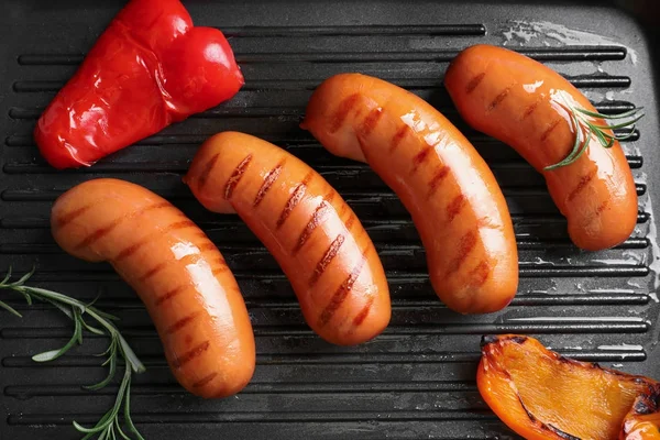 Fried sausages on grill pan — Stock Photo, Image