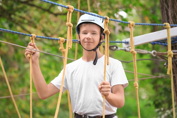 Cute boy climbing in adventure park — Stock Photo, Image