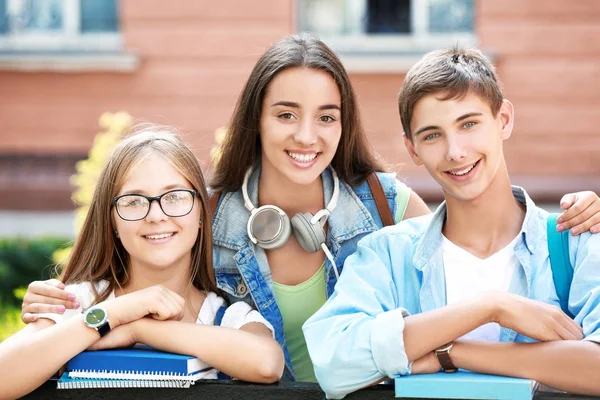 Happy students with books outdoors — Stock Photo, Image