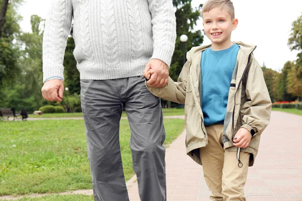Elderly man with grandson in park — Stock Photo, Image