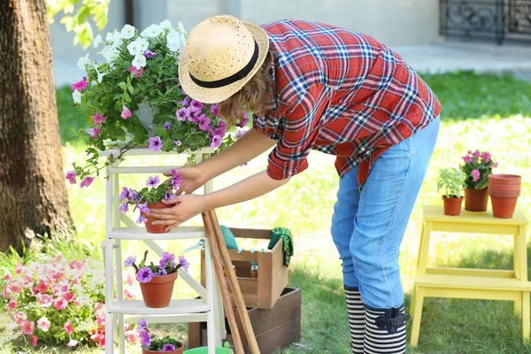 Mulher cuidando de plantas no quintal — Fotografia de Stock