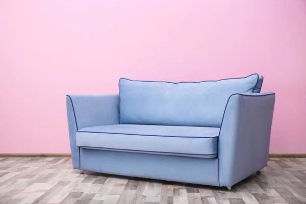 Comfortable sofa against wall
