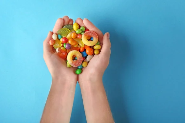 Woman holding colorful candies — Stock Photo, Image