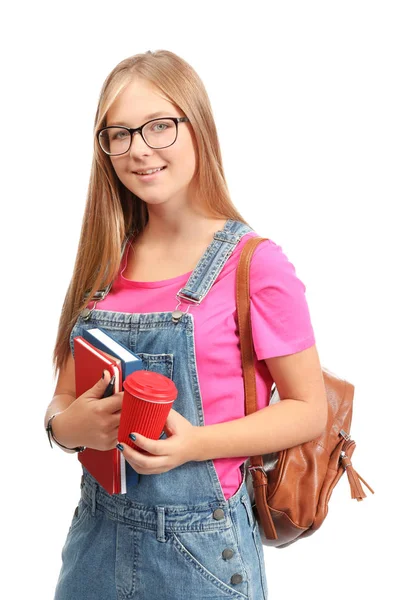 Hübsche Studentin mit Tasse Kaffee und Textbüchern auf weißem Hintergrund — Stockfoto