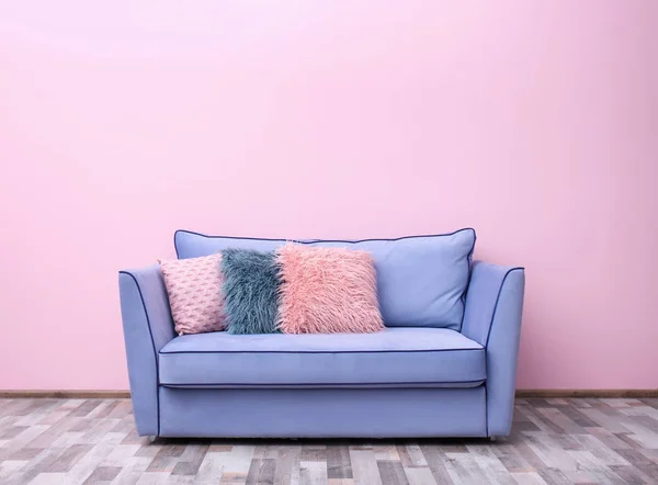 Comfortable sofa against wall — Stock Photo, Image