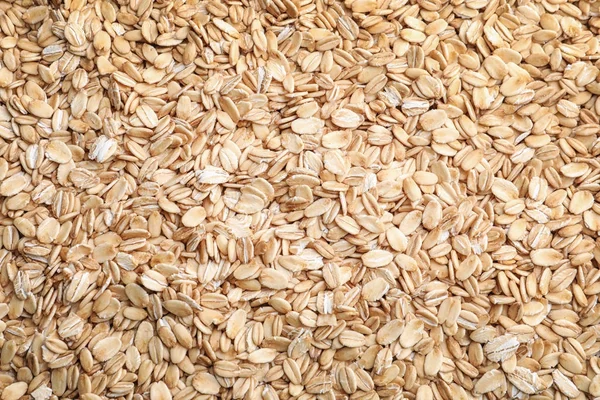 Raw oatmeal as background — Stock Photo, Image