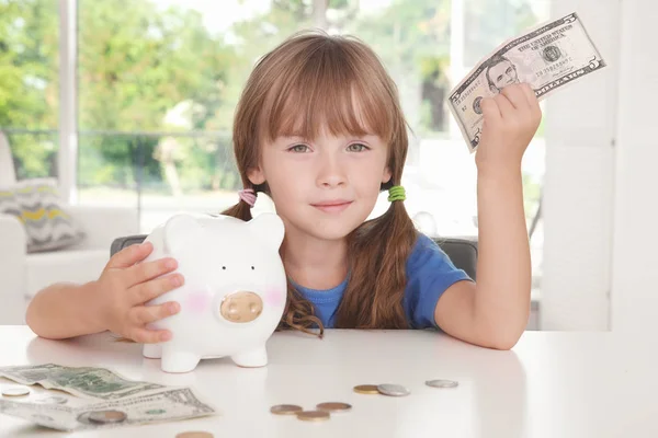 Little girl with piggy bank — Stock Photo, Image