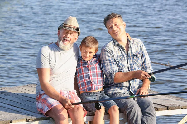 Family fishing on pond together — Stock Photo, Image