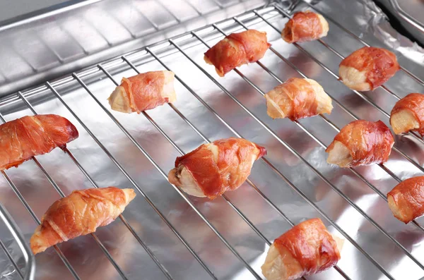 Bagning gitter med bacon indpakket kylling - Stock-foto