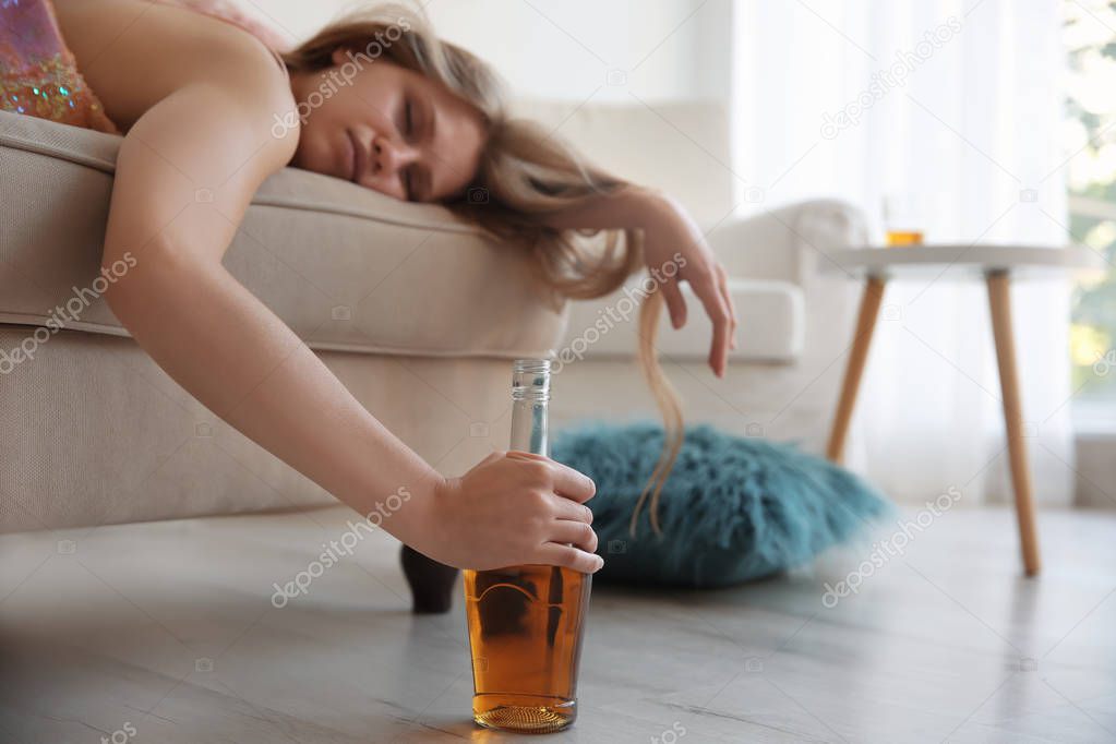 Young woman drinking alcohol 