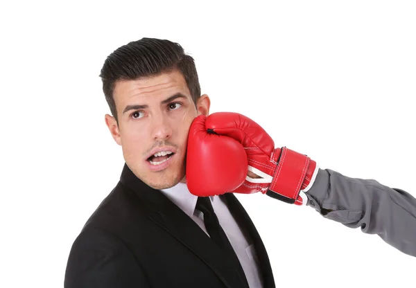 Hand of woman in boxing glove hitting businessman on white background — Stock Photo, Image