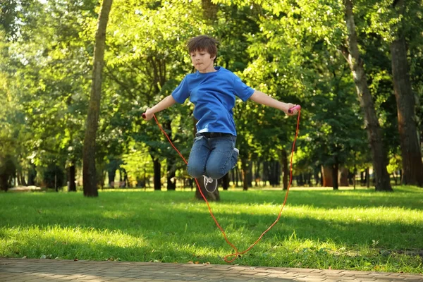 Cute little boy jumping rope — Stock Photo, Image