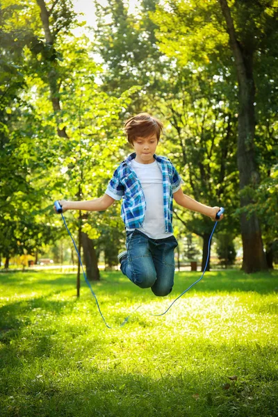 Cute little boy jumping rope — Stock Photo, Image