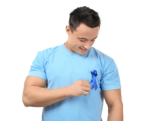 Mladý muž nosí tričko s modrou stuhou na bílém pozadí. Koncept povědomí o rakovině prostaty — Stock fotografie