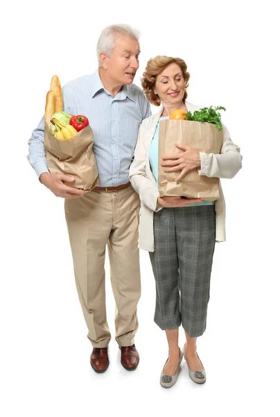 白い背景の上の食料品の紙製の袋を保持している高齢者のカップル — ストック写真