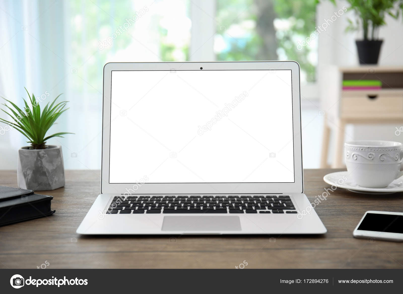 Modern laptop with blank screen on table in office Stock Photo by