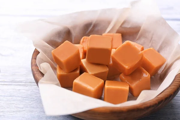 Bowl with tasty caramel candies — Stock Photo, Image