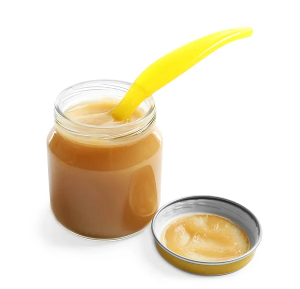 Jar with yummy baby food and spoon — Stock Photo, Image