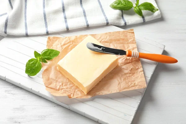 Block of butter on board — Stock Photo, Image