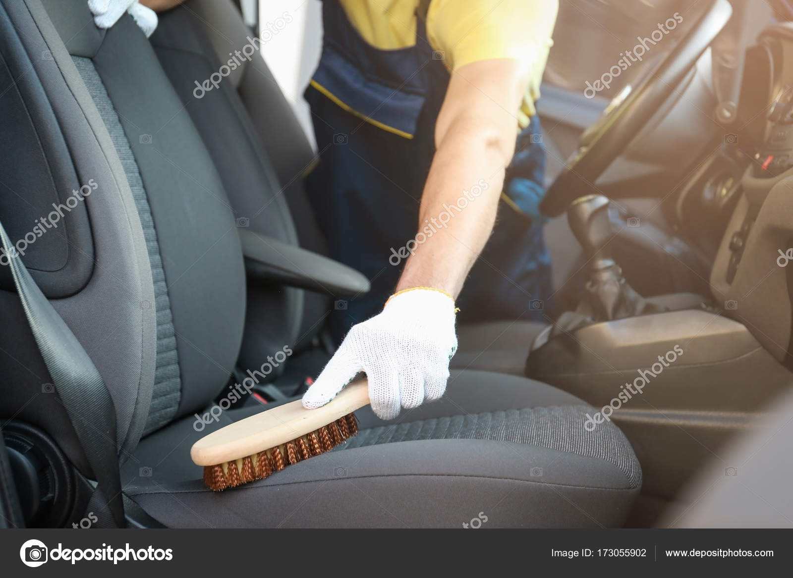 Man Cleaning Salon With Brush In Car Stock Photo
