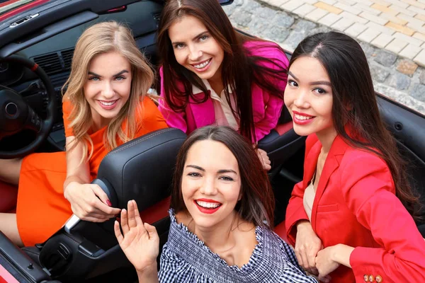 Beautiful young women in cabriolet outdoors — Stock Photo, Image