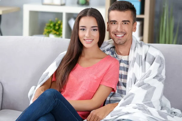 Young couple on sofa at home