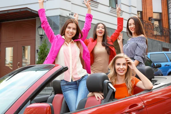 Beautiful young women in cabriolet outdoors — Stock Photo, Image