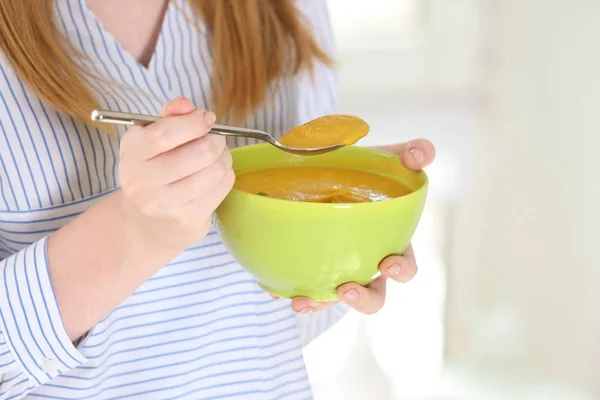 Mulher segurando tigela e colher com lentilhas caseiras sopa de creme — Fotografia de Stock