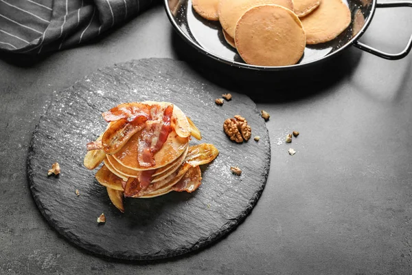Slate plate with pancakes, bacon and fried banana on table — Stock Photo, Image