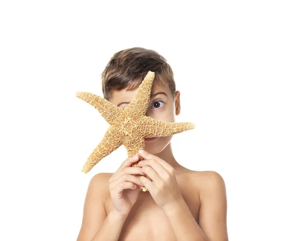 Cute little boy with starfish on white background — Stock Photo, Image