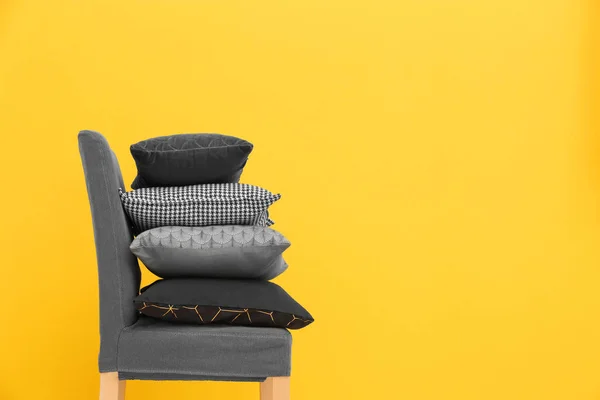 Chair with pillows on color background — Stock Photo, Image