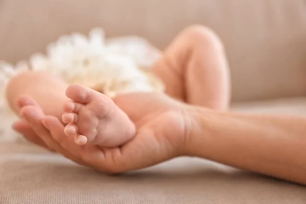 Mother holding leg of baby — Stock Photo, Image