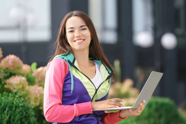 Mujer joven usando el ordenador portátil al aire libre. Concepto de compras por Internet —  Fotos de Stock