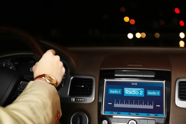 Man listening to radio while driving car — Stock Photo, Image