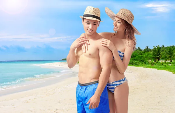 stock image Young couple on beach at tropical resort