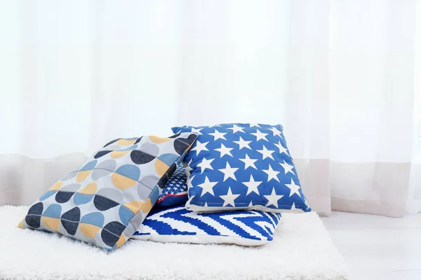 Colorful pillows on floor indoors — Stock Photo, Image