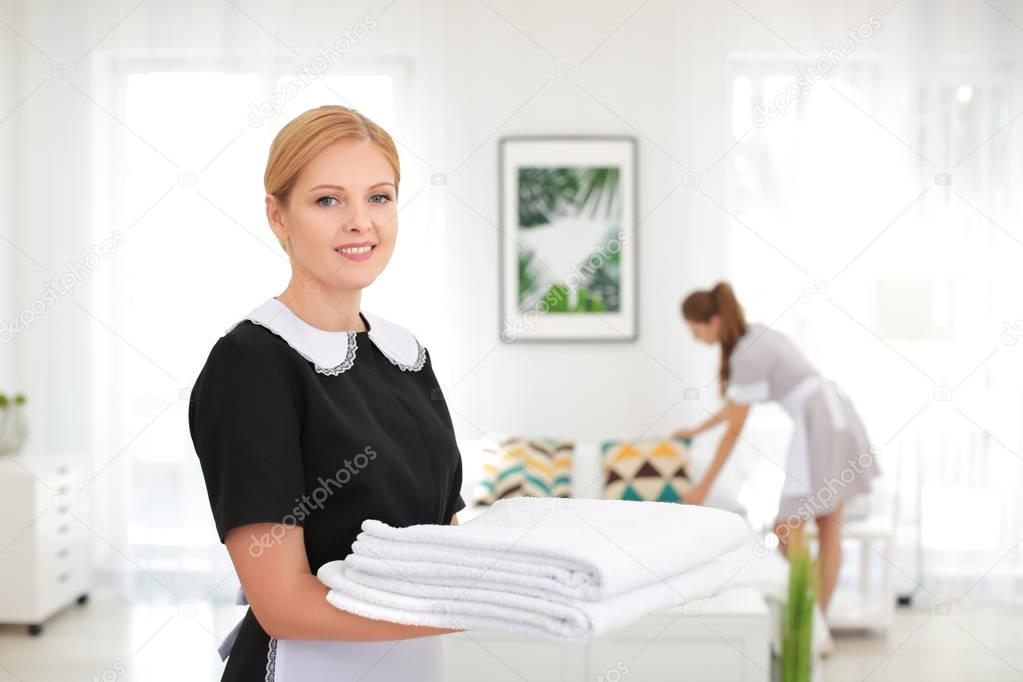 Beautiful chambermaid with towels 