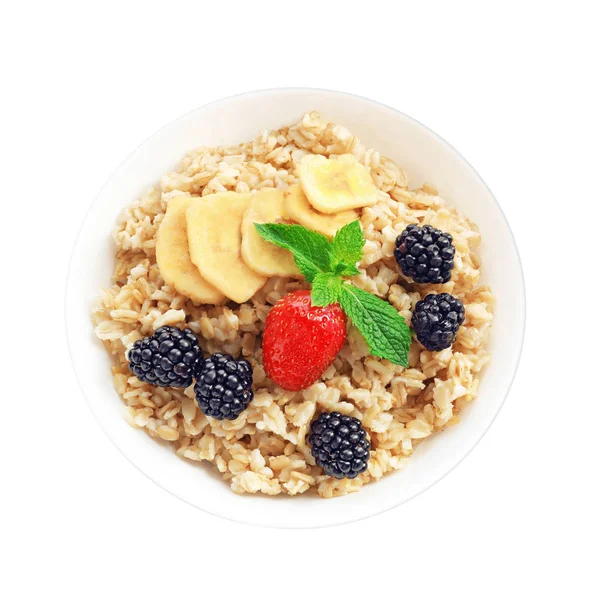 Tasty oatmeal with fruit and berries in bowl on white background — Stock Photo, Image